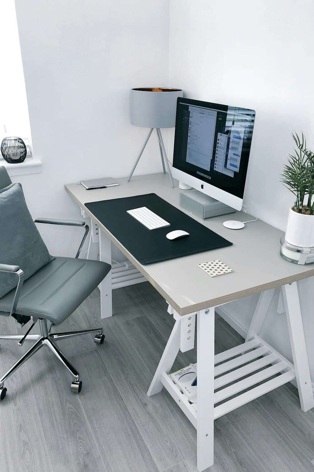 Portrait crop of a bright home office desk set into a white corner