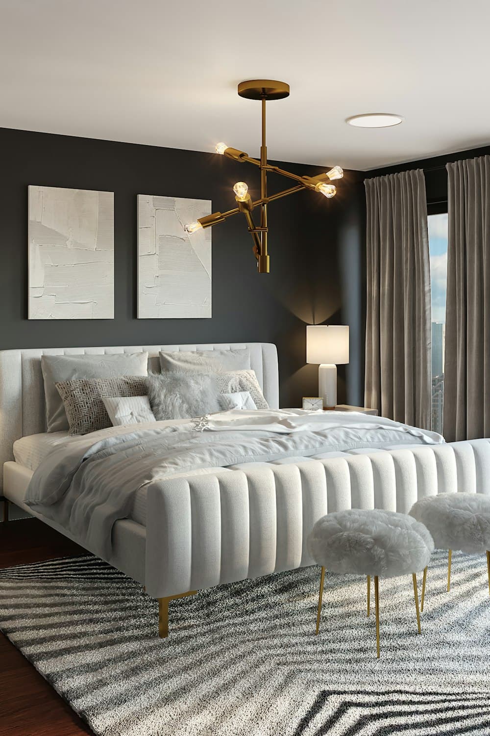 Portrait crop of a gray upholstered bed styled with matching bedside lamps