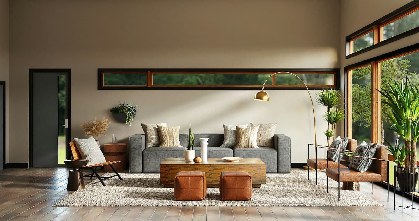 A gray sofa and brass arc floor lamp in a living room with tall windows